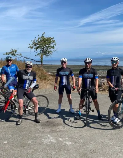 group of cyclists at the beach